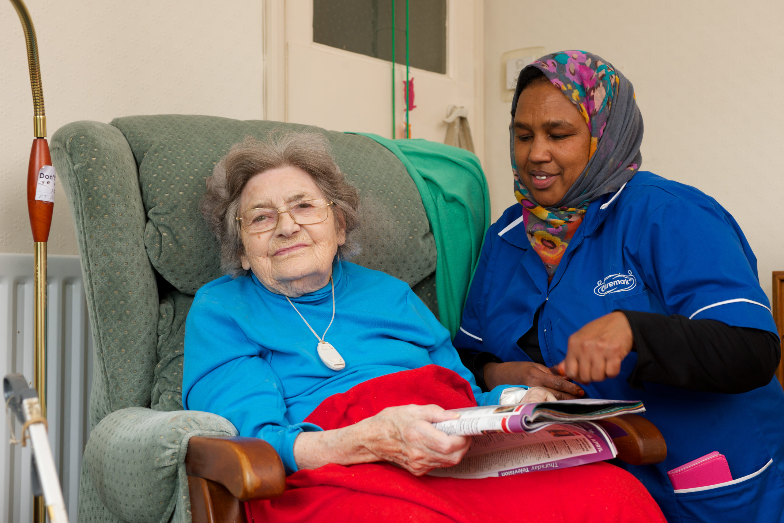 Elderly patient in chair with care assistant